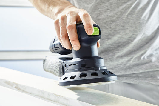 Festool ETSC 125 Akku-Exzenterschleifer mit grünem Schalter in Bedienposition auf Holzwerkstück