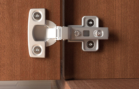 fischer Spanplattenschraube PowerFast FPF II CTF BC befestigt präzise ein Topfscharnier an einem Holzschrank – perfekte Verbindung für Möbelmontagen.